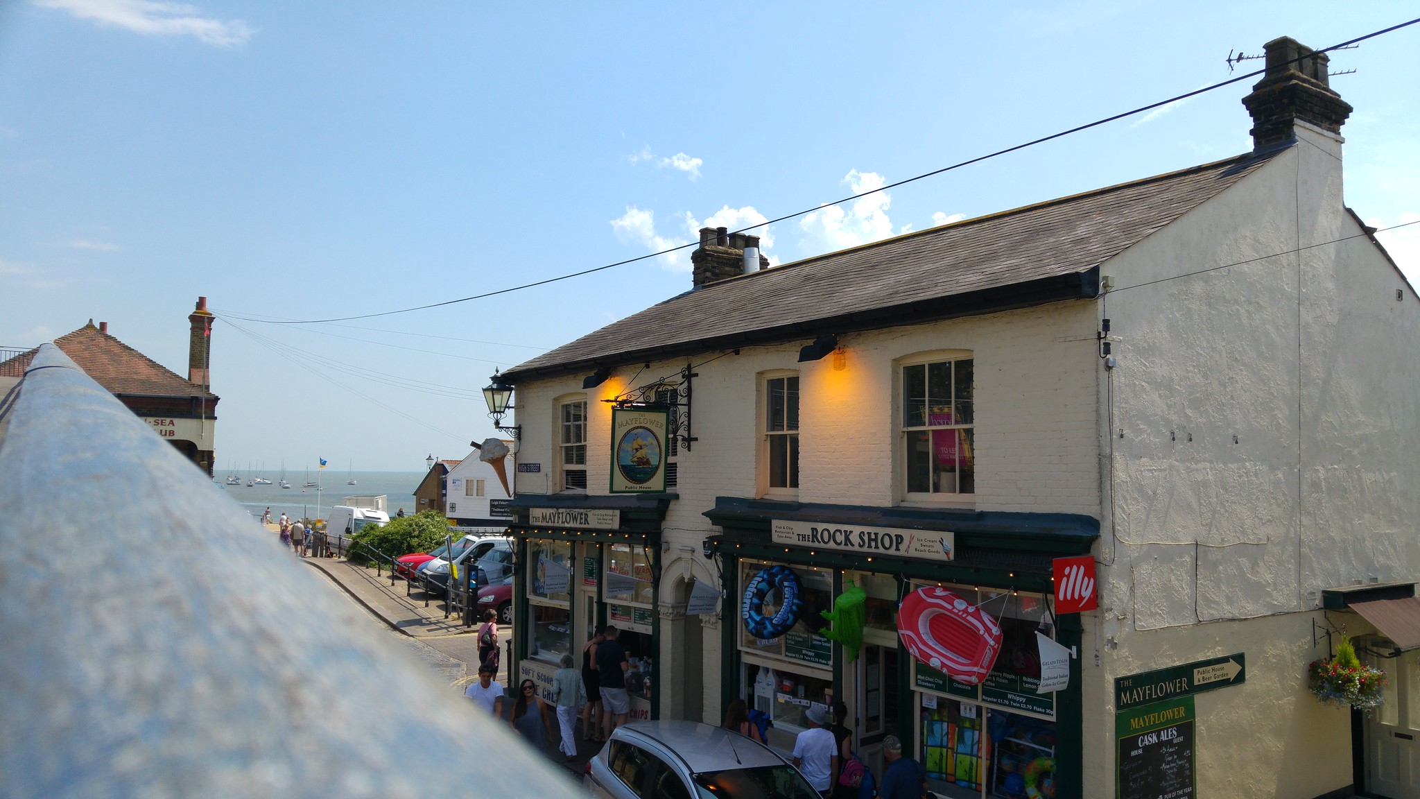 Old Leigh High Street with the Mayflower pub, shops and the Thames Estuary visible at the end of the street.